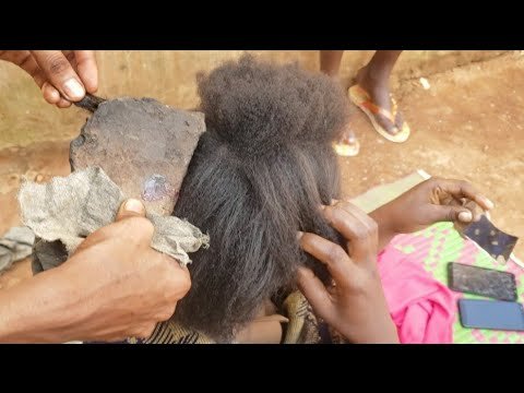 Typical Village African way of blow drying Hair Using broken pots
